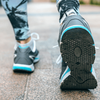 Close up of the shoes of a person walking.